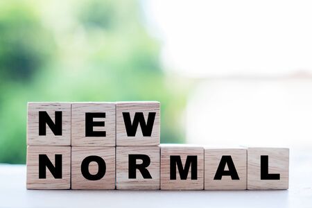 NEW NORMAL cube blocks on table background, the end of Coronavirus pandemic. Human lifestyle Behavior will change such as using face mask, personal hygiene, Work from Home and Social distancingの写真素材