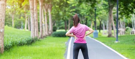 Young adult female with his muscle pain during running. runner woman having back body ache due to...