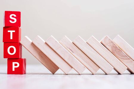 Red STOP cube blocks stop falling blocks on table. fall Business, planning, risk Management, Solution, Insurance and strategy Conceptsの写真素材