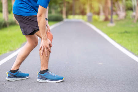 Young adult male with muscle pain during running. runner have knee ache due to Runners Knee or Patellofemoral Pain Syndrome, osteoarthritis and Patellar Tendinitis. Sports injuries and medical conceptの写真素材