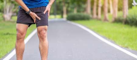 Young adult male with muscle pain during running. runner have leg ache due to Groin Pull. Sports injuries and medical conceptの写真素材