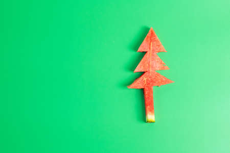Christmas tree of watermelon on green background. Merry Xmas and happy New Year party, Celebrating...