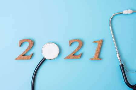 2021 Happy New Year for healthcare, Wellness and medical concept. Stethoscope and wooden number on...