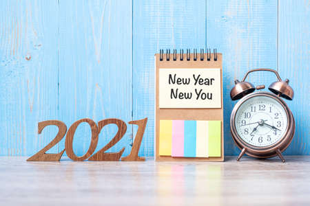 2021 New Year  New Yoy with blank notebook, retro alarm clock and wooden number. New Start,...