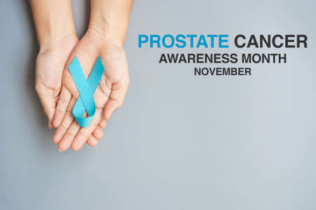November Prostate Cancer Awareness month, Man holding light Blue Ribbon for supporting people living...