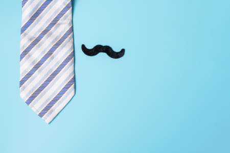 blue neckties and mustache on blue background. Happy Father's Day and International Men's Day conceptsの写真素材