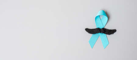 November Prostate Cancer Awareness month, light Blue Ribbon with mustache for supporting people...
