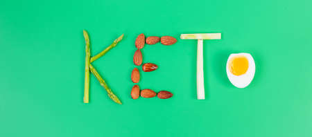 KETO arrangement of Organic Asparagus, Almond, Broccoli and boiled Egg on green background. weight loss, ,Healthy food, Ketogenic diet, low carb and vegetarian conceptの写真素材