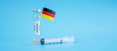 COVID-19 Vaccine vial, injection Needle Syringe and German flag against Coronavirus infection in hospital laboratory. Medical, health, Vaccination and immunization conceptの写真素材
