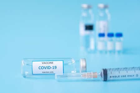 COVID-19 Vaccine vial and injection Needle Syringe against Coronavirus infection in hospital laboratory. Medical, health, Vaccination and immunization conceptの写真素材