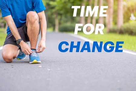 Time for Change with Young man tying shoelace in the park outdoor, athlete runner man ready for...