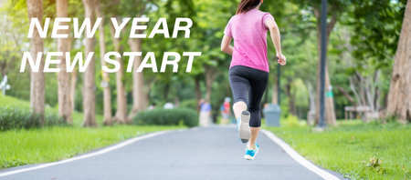 New Year New Start with Young woman running in the park outdoor, asian Athlete jogging and exercise on the road in morning. Fitness, wellness, healthy lifestyle, resolution and New You conceptsの写真素材