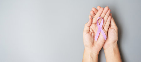 World cancer day (February 4). Woman hand hoy Lavender purple ribbon for supporting people living and illness. Healthcare and medical conceptの写真素材