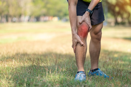 young adult male with muscle pain during running. runner have knee ache due to Runners Knee or Patellofemoral Pain Syndrome, osteoarthritis and Patellar Tendinitis. Sports injuries and medical conceptの写真素材