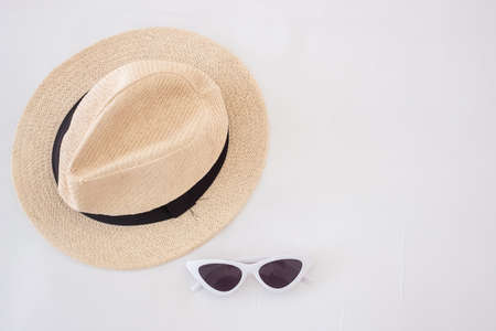 white sunglasses and hat on bed. Summer travel, vacation, holiday and weekend conceptの写真素材