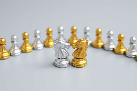 Gold and silver Chess Knight (horse) figure against pawn. Strategy, Conflict, management, business planning, tactic, politic, communication and leader conceptの写真素材