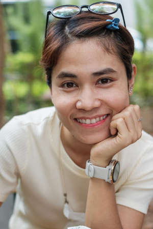Happy beautiful woman smiling and cheerful at the cafe, young asian girl holding ice coffee