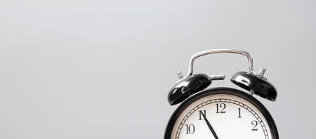 Vintage alarm clock on wooden tableの写真素材