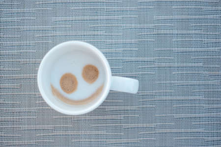 Smile face shape of hot cappuccino coffee.の写真素材