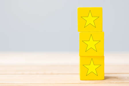 wooden blocks with the star symbol. Customer reviews, feedback, rating, ranking and service concept.の写真素材