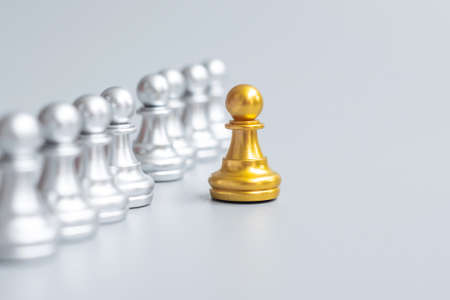 Golden chess pawn pieces or leader businessmen stand out of crowd people of silver men.の写真素材