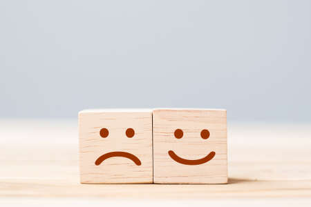 emotion face symbol on wooden cube blocks. Service rating, ranking, customer review, satisfaction...