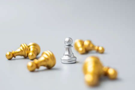 Silver chess pawn figure stand out from crowd of enemy or opponent.の写真素材