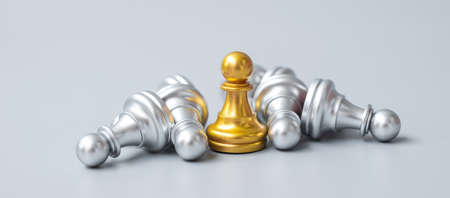 Gold chess pawn figure stand out from crowd of enermy or opponent.の写真素材