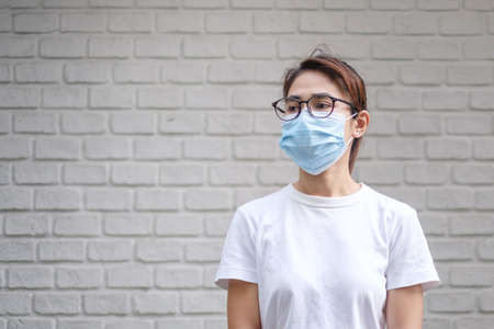 Woman wearing medical face mask, prevent coronavirus or Corona Virus Disease (Covid-19). Health conceptの写真素材