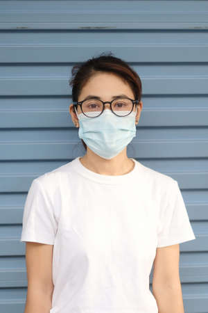 Woman wearing medical face mask, prevent coronavirus or Corona Virus Disease (Covid-19). Health conceptの写真素材