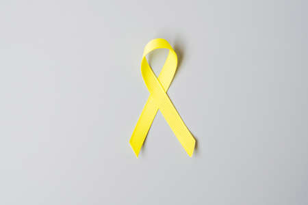 Childhood Cancer, Sarcoma, bone, bladder and Suicide prevention Awareness month, Gold Yellow Ribbon for supporting people living and illness. children Healthcare and World cancer day conceptの写真素材