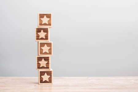 star symbol block on table background. Service rating, ranking, customer review, satisfaction, evaluation and feedback conceptの写真素材