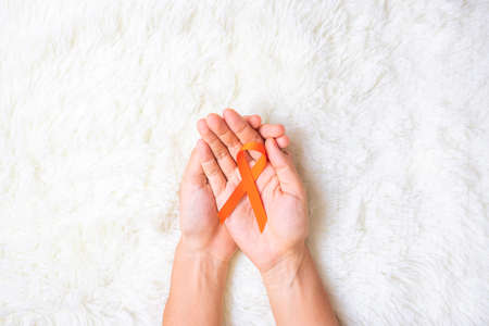 Leukemia, Kidney cancer day, world Multiple Sclerosis, CRPS, Self Injury Awareness month, Orange Ribbon for supporting people living and illness. Healthcare and World cancer day conceptの写真素材