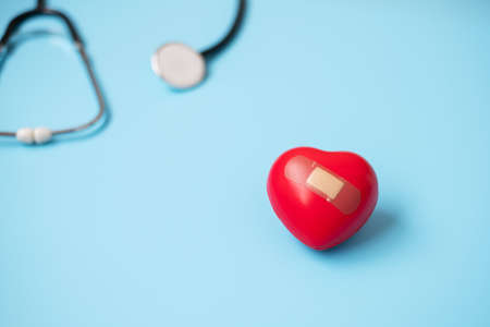 Top view Stethoscope with Red heart shape on blue background with copy space for text. Healthcare,...