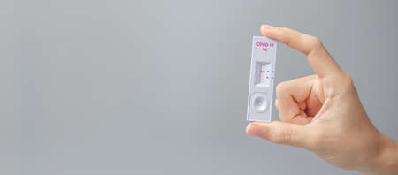 man holding Rapid Antigen Test kit with Negative result during swab COVID-19 testing. Coronavirus...