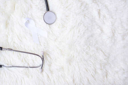 white Ribbon with stethoscope on white color background. November Lung Cancer Awareness month conceptの写真素材