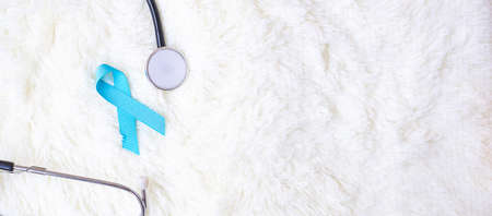 November Prostate Cancer Awareness, light Blue Ribbon with stethoscope for supporting people living and illness. Diabetes day, International men and World cancer day conceptの写真素材
