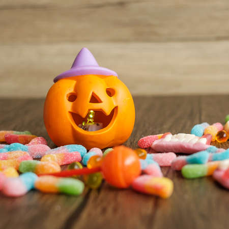 Happy Halloween day with ghost candies, pumpkin bowl, Jack O lantern and decorative (selective focus). Trick or Threat, Hello October, fall autumn, Festive, party and holiday conceptの写真素材