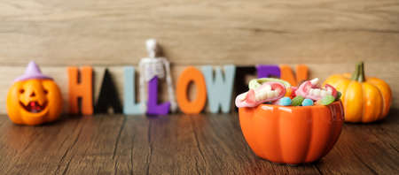 Happy Halloween day with ghost candies, pumpkin bowl, Jack O lantern and decorative (selective focus). Trick or Threat, Hello October, fall autumn, Festive, party and holiday conceptの写真素材
