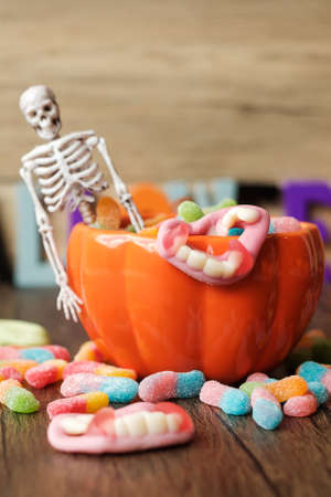 Happy Halloween day with ghost candies, pumpkin bowl, Jack O lantern and decorative (selective focus). Trick or Threat, Hello October, fall autumn, Festive, party and holiday conceptの写真素材