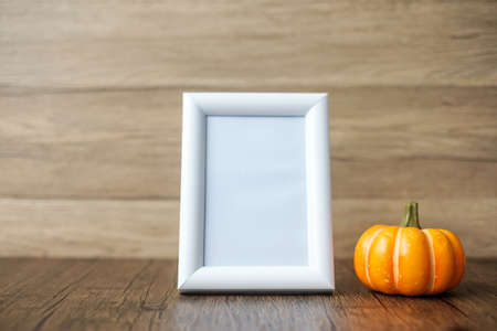 Orange pumpkin on table and frame with copy space for text. Happy Halloween day, Hello October, fall...