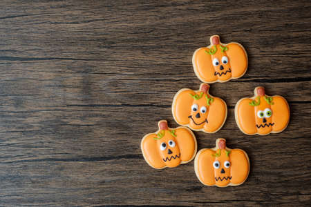 Happy Halloween day with funny Cookies set on wooden table background. Trick or Threat, Hello...