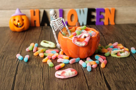 Happy Halloween day with ghost candies, pumpkin bowl, Jack O lantern and decorative (selective...