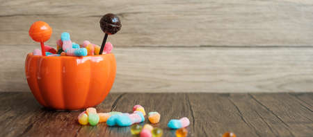 Happy Halloween day with ghost candies, pumpkin bowl, Jack O lantern and decorative (selective focus). Trick or Threat, Hello October, fall autumn, Festive, party and holiday conceptの写真素材