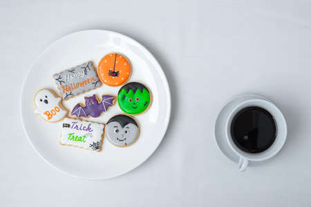 hot coffee cup with funny Halloween Cookies. Happy Halloween day, Trick or Threat, Hello October, fall autumn, Traditional, party and holiday conceptの写真素材