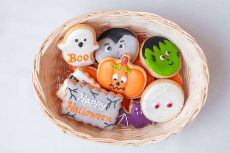 Halloween funny Cookies in wooden basket. Trick or Threat, Happy Halloween, Hello October, fall autumn, Festive, party and holiday conceptの写真素材