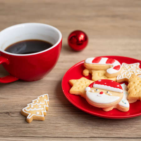 Merry Christmas with homemade cookies and coffee cup on wood table background. Xmas eve, party, holiday and happy New Year conceptの写真素材