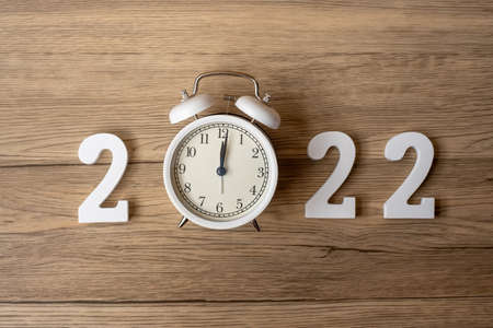 2022 Happy New Year  with retro alarm clock and wooden number. Merry Christmas, New Start, Resolution, countdown, Goals, Plan, Action and Mission Conceptの写真素材