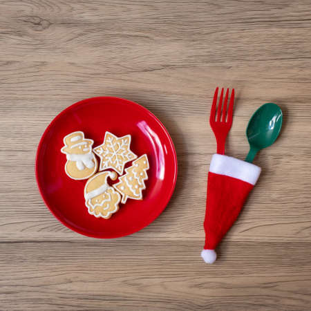 Merry Christmas with homemade cookies, fork and spoon on wood table background. Xmas, party and happy New Year conceptの写真素材