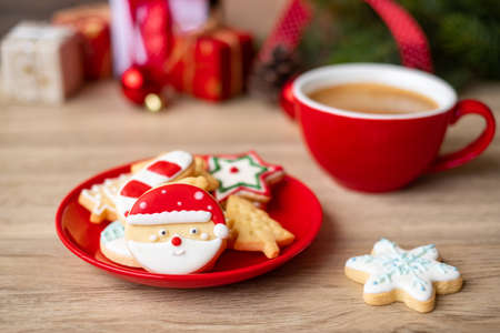 Merry Christmas with homemade cookies and coffee cup on wood table background. Xmas eve, party, holiday and happy New Year conceptの写真素材